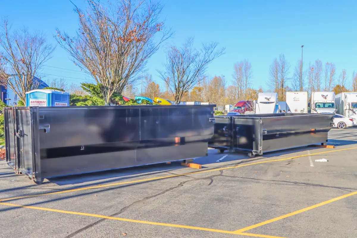 Professional dumpster rental service with roll-off container on residential driveway in Morris